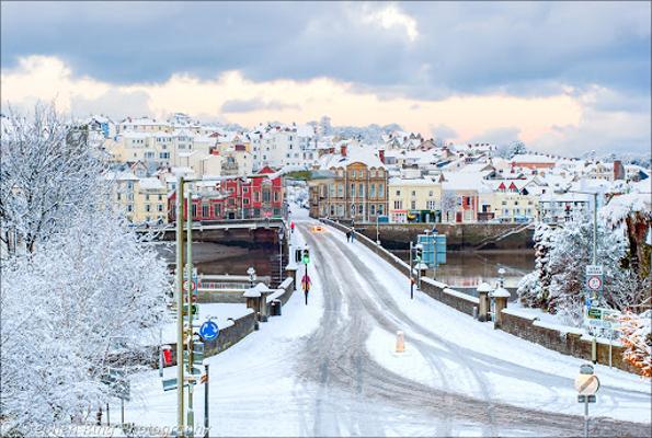 Photo of Bideford Bridge and the surrounding houses and buildings in the Snow