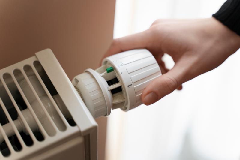 Man turning on heater