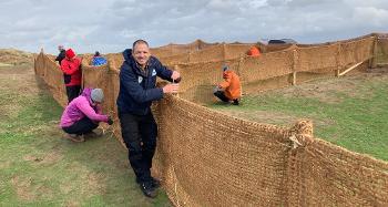 Lead Ranger Mike Day and volunteers working on a fence 
