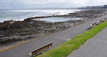 Picture of Westward Ho! Rockpool, with a bench on the path overlooking the pool