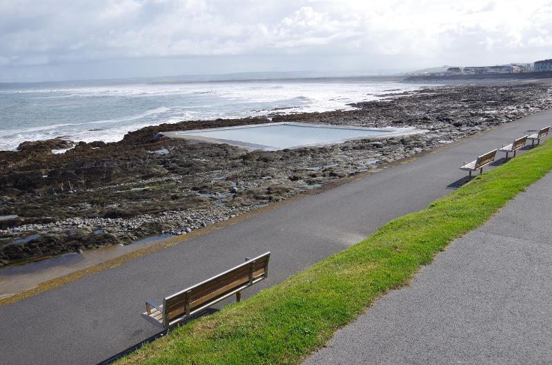 Picture of Westward Ho! Rockpool, with a bench on the path overlooking the pool