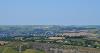 DCA 14: Far-reaching views north-east from Codden Hill across Venn Quarry towards Barnstaple, with Fullabrook Down Wind Farm visible on the skyline.