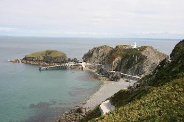 LCT 6 The approach to Lundy at the south of the Island with South Lighthouse, ferry jetty and access road winding up the steep cliff side.