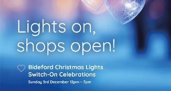 Poster for Bideford Christmas events with glowing heart ornaments and text: “Lights on, shops open! Switch-On Dec 3, Market Dec 9.
