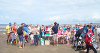 Photo of children and their families listening to the Ranger on the beach before going off to the rockpools
