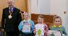 Councillor Doug Bushby with the winner and two runners-up of the Christmas Card Competition