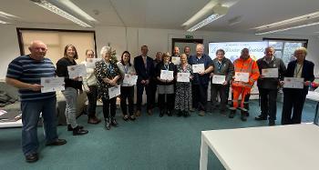 Photo of the staff and their certificates at the Long Service Awards Ceremony 