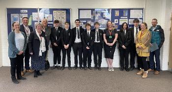 Various students, staff, Torridge Councillors and Officers smiling for a photo at Great Torrington School