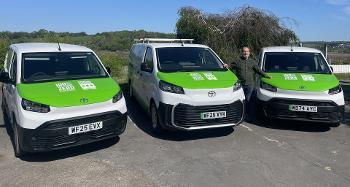 Photo of 3 of the new TDC Electric Vehicles, they are white vans with green bonnets