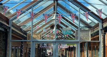 Photo of the front of the new Torrington Pannier Market, with union jack bunting going across the doors