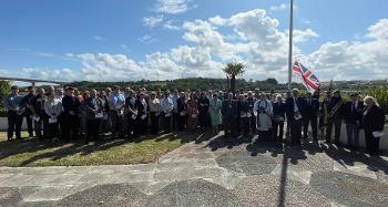 Torridge Officers and Councillors commemorating armed forces day by Riverbank House's flagpole