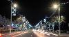 Picture of the road along Bideford Quay at night time, with car lights and the christmas lights