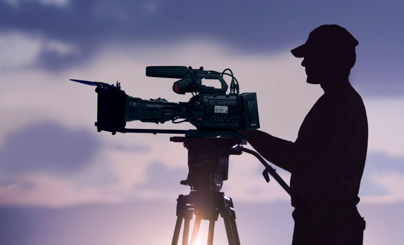 Camera man in Devon with the sunset in the background